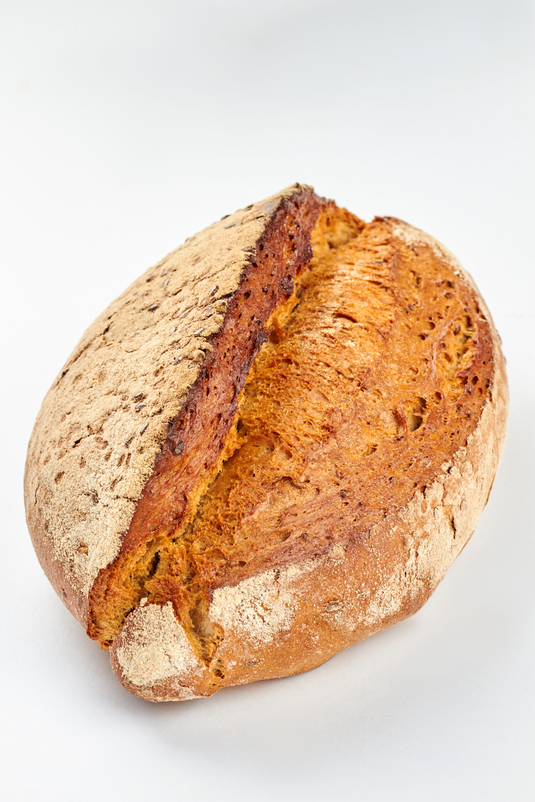 Rustic homemade bread on white background. Loaf of rye bread. Healthy organic food.